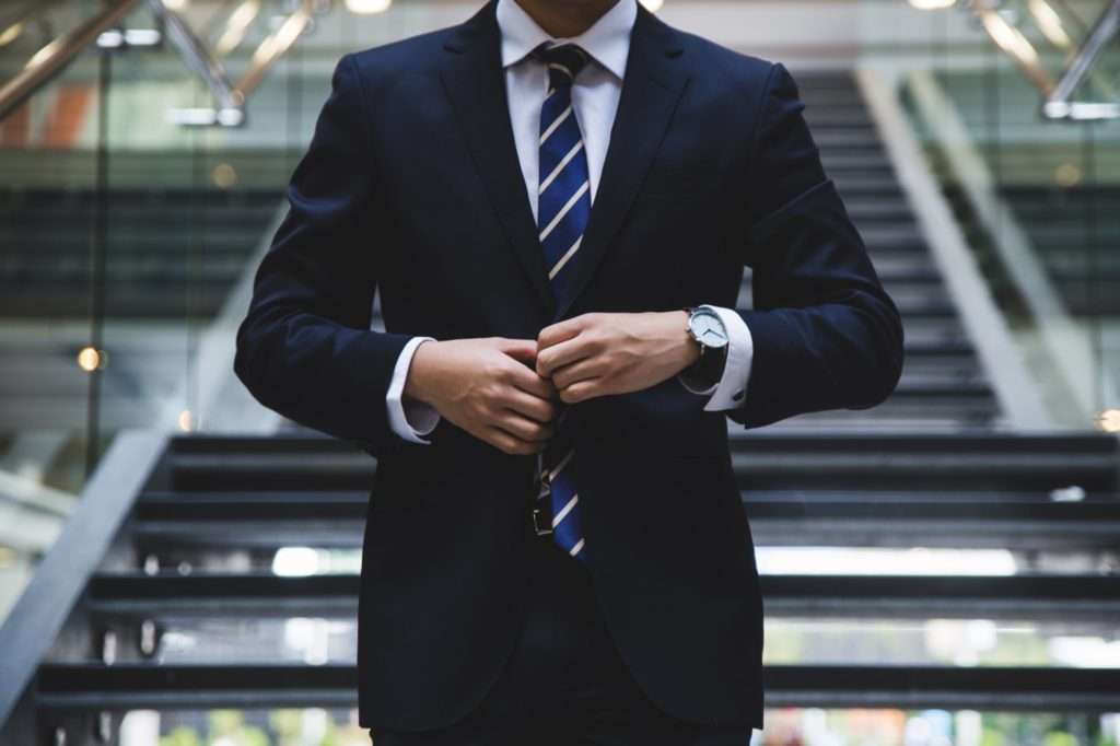 businessman standing in pressed new suit