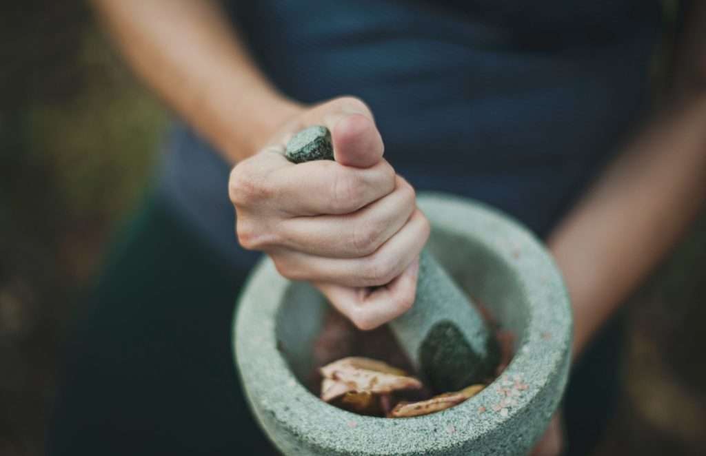 someone using a mortar and pestle