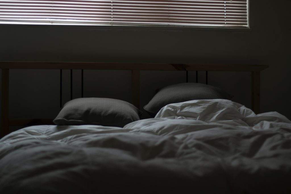 dark bedroom as prescribed by a sleep coach