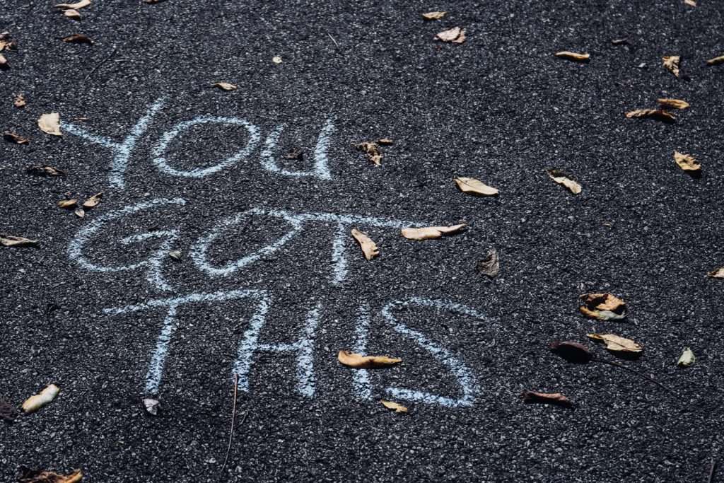 Message of confidence written in chalk on the street of you got this